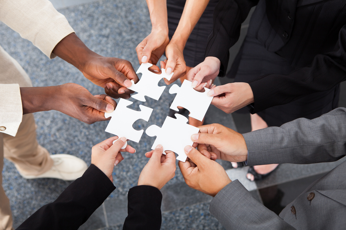 Businesspeople Holding Jigsaw Puzzle